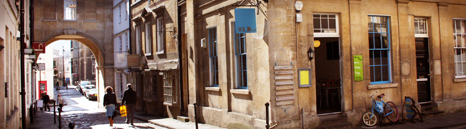 Wild Cafe on Queen Street, Bath — the blue sign under the archway